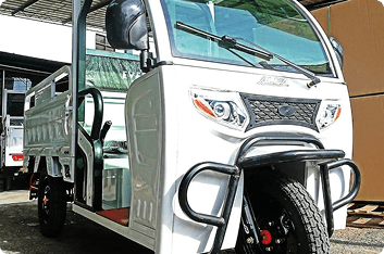 A white electric three-wheeler cargo vehicle