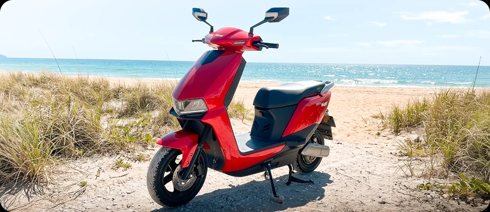 Red ALFA electric scooter parked on a coastal sand track